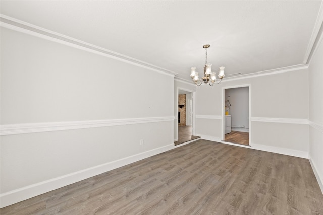 unfurnished dining area featuring hardwood / wood-style flooring, an inviting chandelier, and ornamental molding