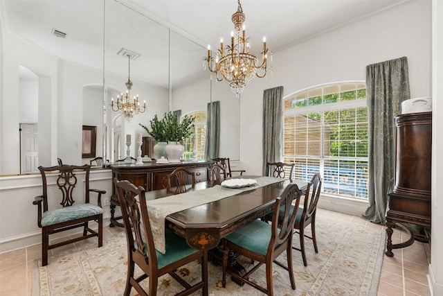 dining area featuring an inviting chandelier, ornamental molding, and light tile patterned floors