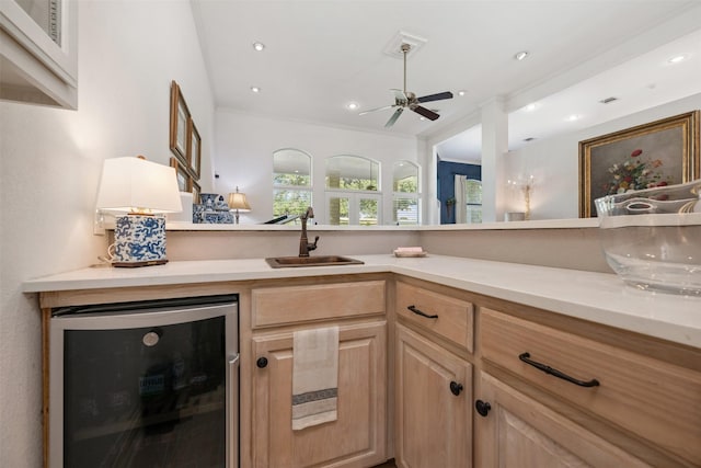 kitchen featuring sink, crown molding, ceiling fan, wine cooler, and light brown cabinets