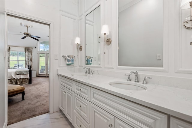 bathroom featuring ceiling fan, vanity, and ornamental molding