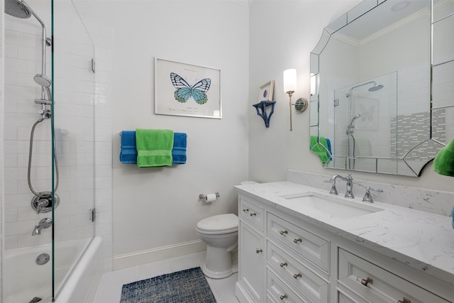 full bathroom featuring tile patterned flooring, vanity, tiled shower / bath combo, toilet, and crown molding