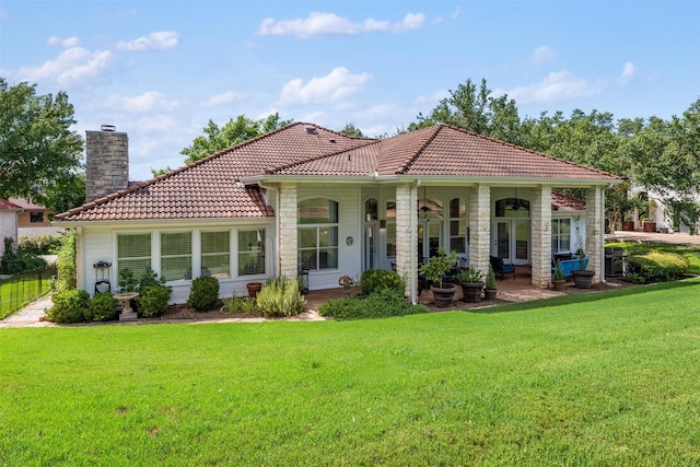 rear view of property with a porch and a lawn