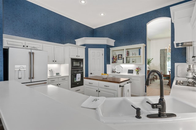 kitchen with sink, white cabinets, wood counters, and black appliances