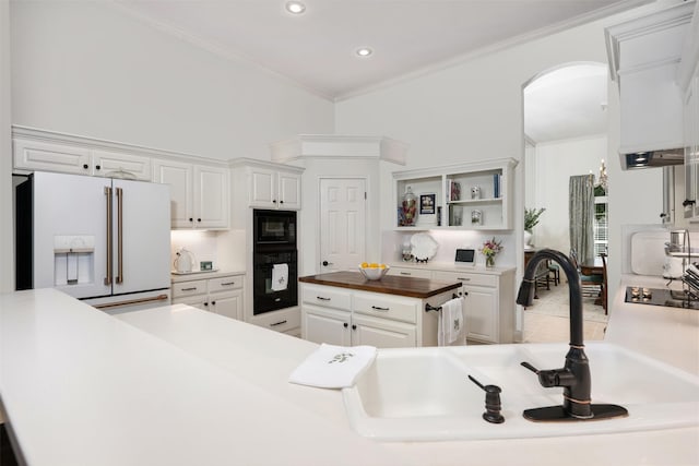 kitchen with butcher block countertops, sink, black appliances, decorative backsplash, and white cabinets