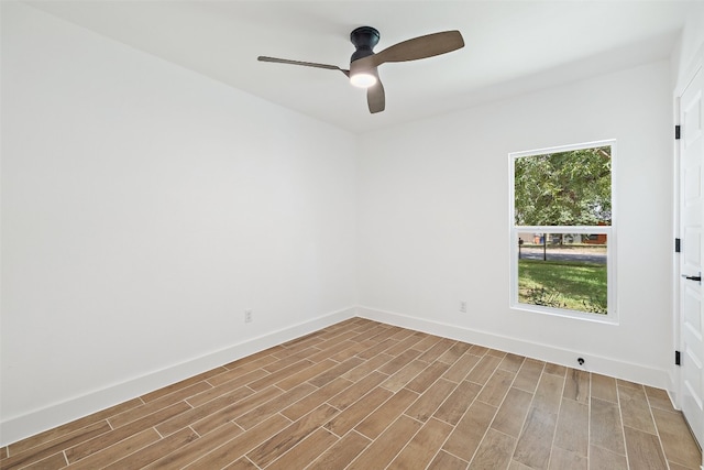 spare room with light wood-type flooring and ceiling fan