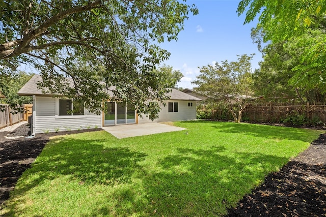 back of property with a patio area and a lawn