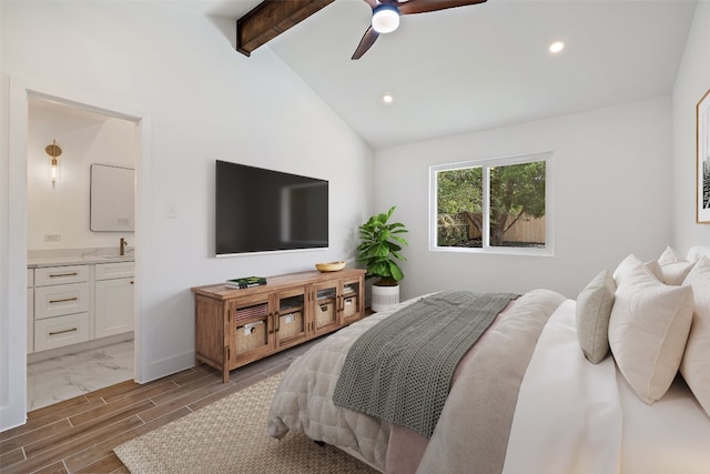 bedroom featuring connected bathroom, hardwood / wood-style floors, ceiling fan, and lofted ceiling with beams