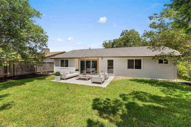 rear view of property featuring an outdoor living space, a patio area, and a yard