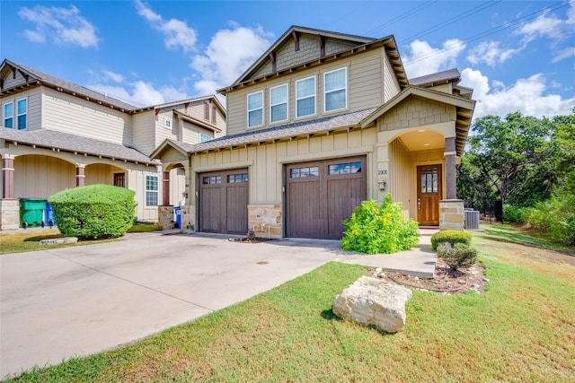 craftsman-style home featuring a garage and central AC unit