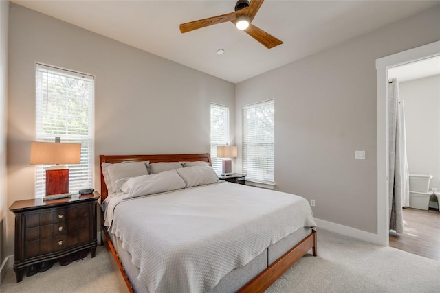 bedroom with multiple windows, light carpet, and ceiling fan