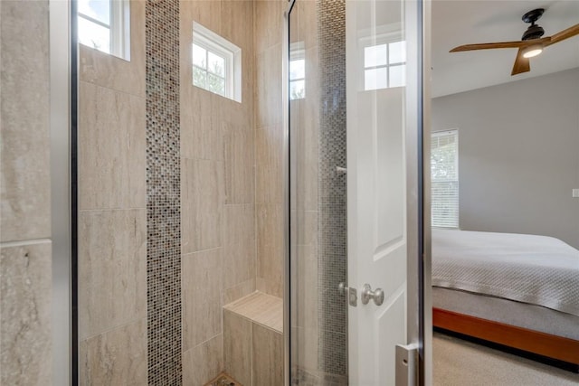 bathroom featuring tiled shower and ceiling fan