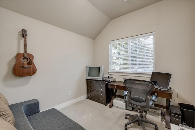 home office featuring light colored carpet and vaulted ceiling