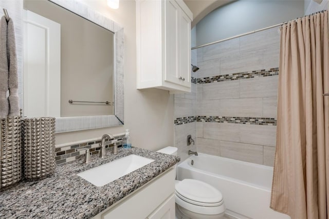 full bathroom with vanity, toilet, shower / bath combo with shower curtain, and tasteful backsplash