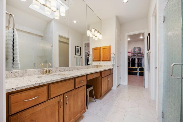 bathroom featuring vanity and an enclosed shower