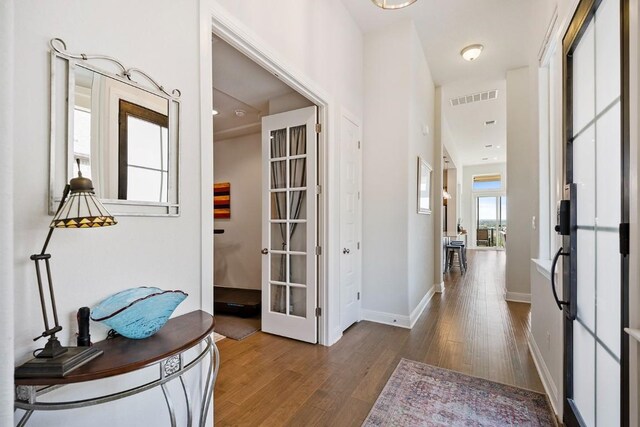 corridor featuring dark hardwood / wood-style flooring