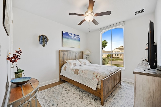 bedroom with light hardwood / wood-style flooring and ceiling fan