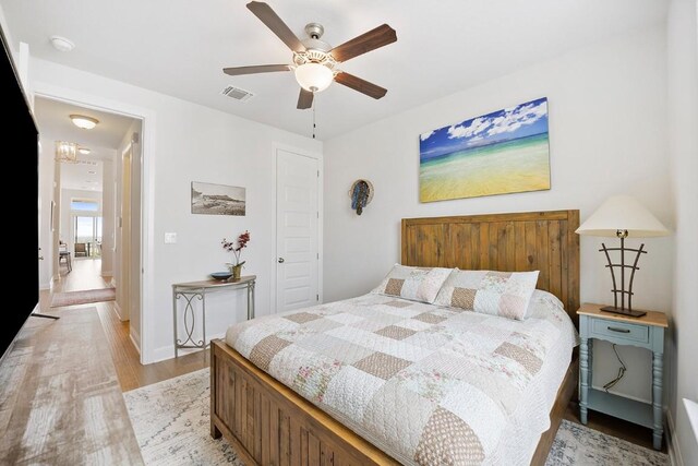 bedroom featuring light hardwood / wood-style floors and ceiling fan