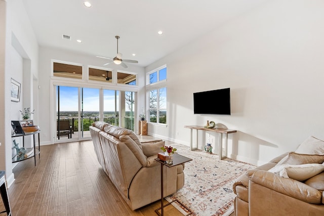 living room featuring ceiling fan and hardwood / wood-style flooring