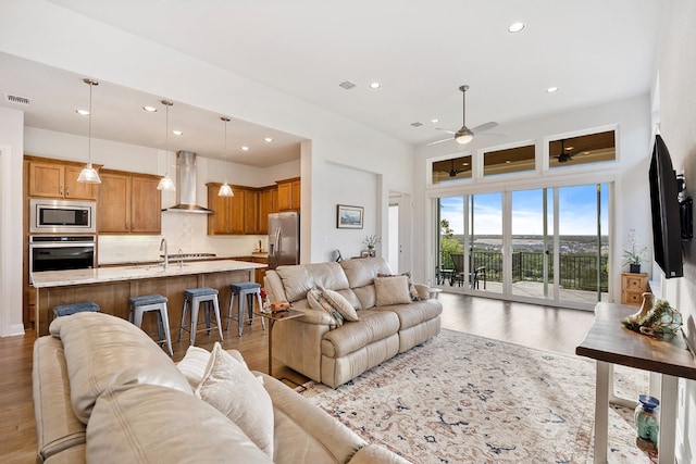 living room featuring ceiling fan and hardwood / wood-style flooring