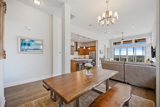 dining space featuring ceiling fan with notable chandelier and dark wood-type flooring