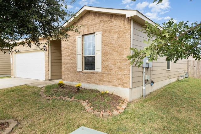 view of home's exterior with a yard and a garage