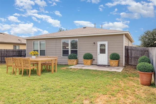 back of house featuring a patio and a yard