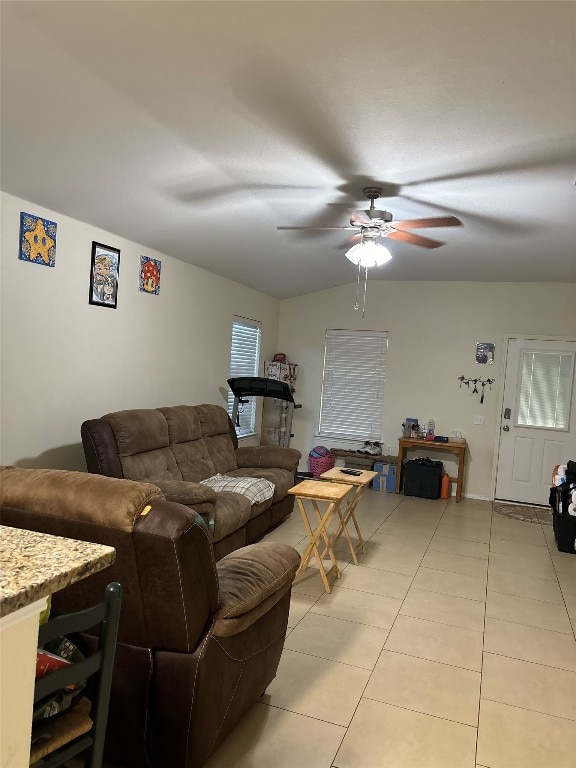 living area with ceiling fan and light tile patterned floors