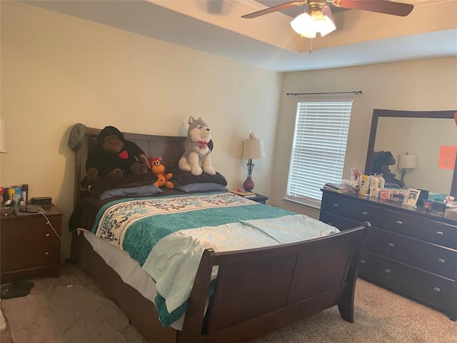 bedroom featuring carpet flooring, ceiling fan, and a tray ceiling