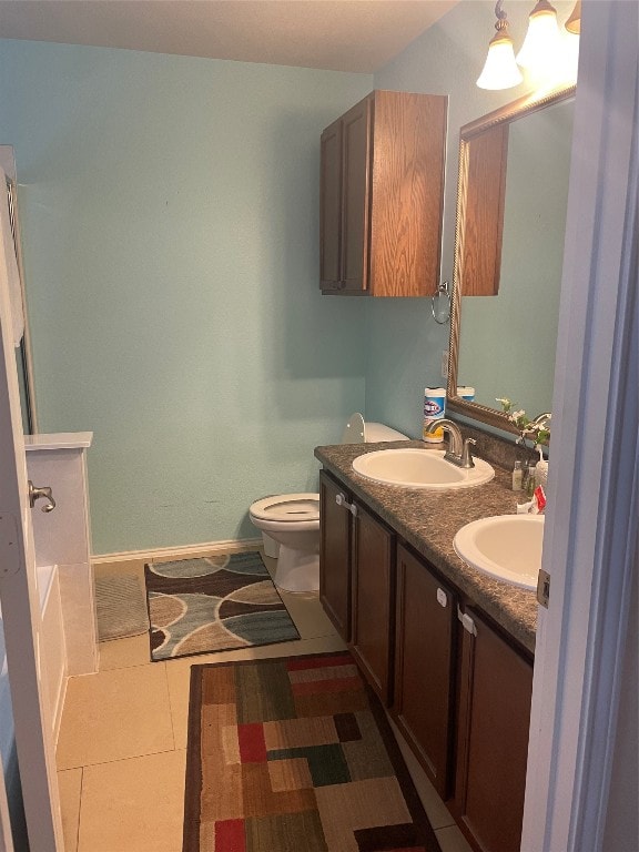 bathroom with vanity, toilet, and tile patterned flooring