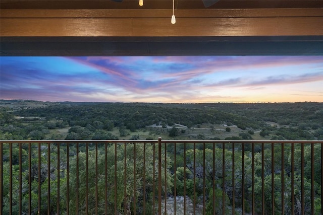 balcony at dusk with a view of trees