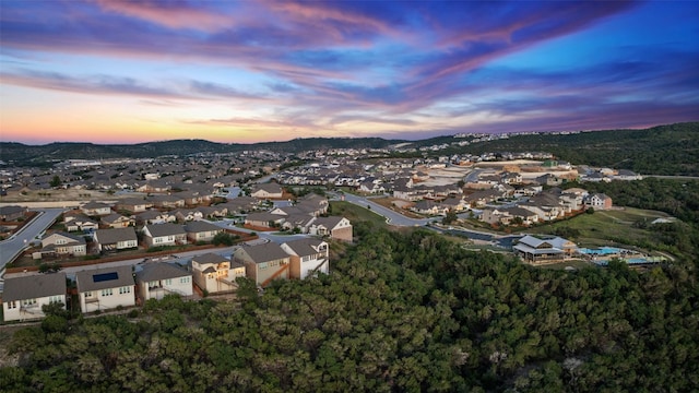 aerial view at dusk with a mountain view and a residential view