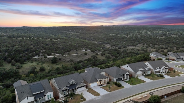 birds eye view of property with a residential view and a forest view