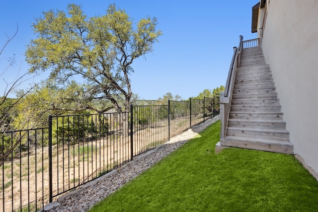 view of yard with stairway and fence