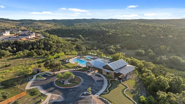 birds eye view of property featuring a view of trees