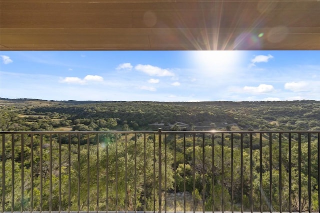 balcony featuring a view of trees