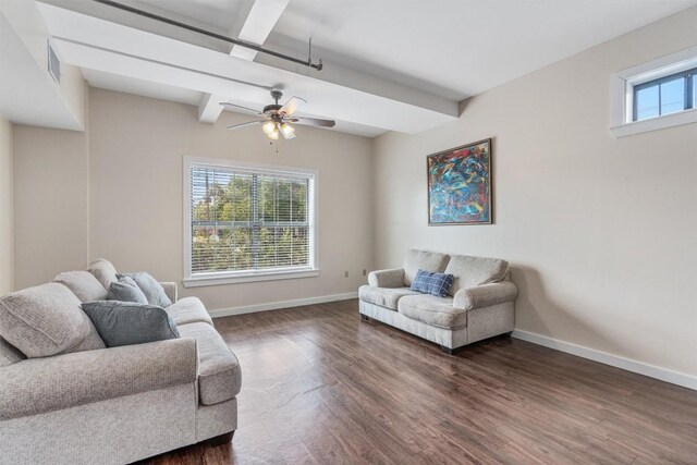 living room featuring beam ceiling, ceiling fan, and dark wood-type flooring