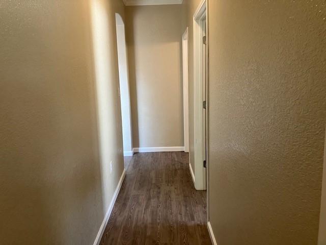 hall with dark hardwood / wood-style floors