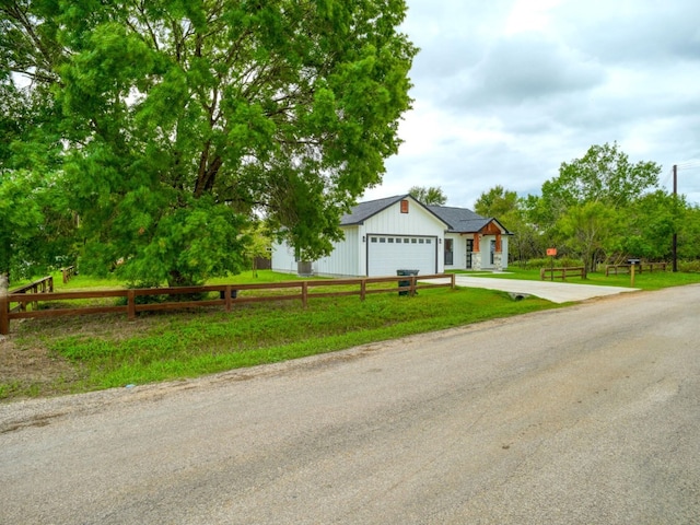 view of front of property with a front lawn and a garage