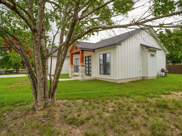 rear view of house featuring a lawn