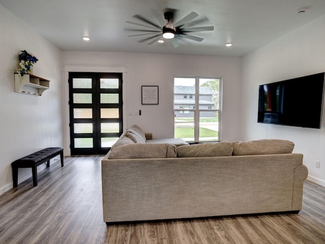 living room with hardwood / wood-style floors, ceiling fan, and french doors