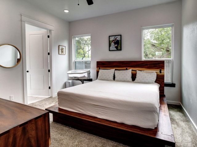 bedroom with carpet, multiple windows, and ceiling fan