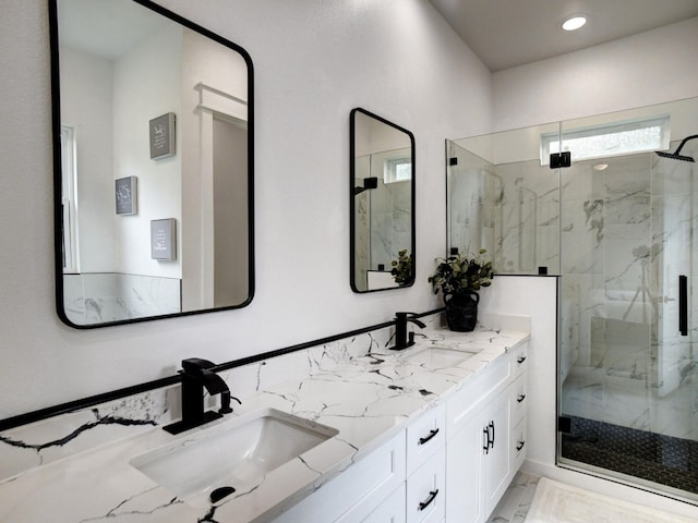 bathroom with vanity and a shower with shower door