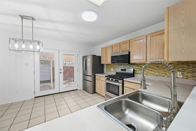 kitchen with hanging light fixtures, light brown cabinets, stainless steel appliances, and sink