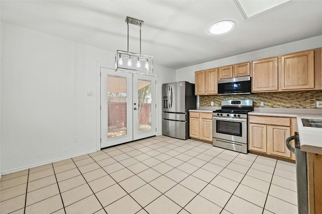 kitchen featuring hanging light fixtures, french doors, appliances with stainless steel finishes, light brown cabinets, and tasteful backsplash