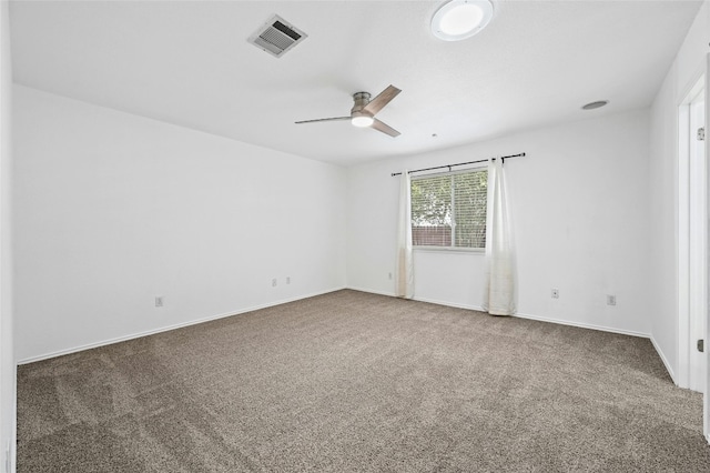 carpeted spare room featuring ceiling fan