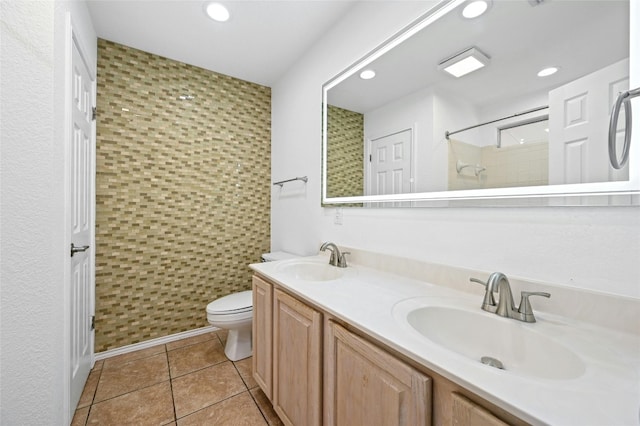 bathroom featuring tile patterned floors, walk in shower, toilet, and vanity