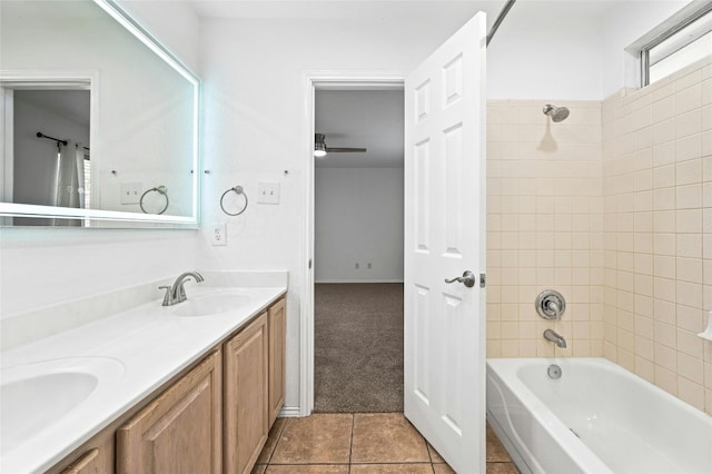 bathroom featuring tiled shower / bath combo, vanity, and tile patterned floors