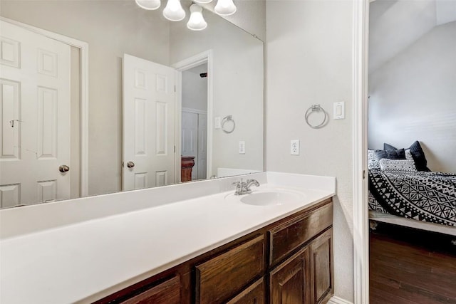 1102 Canyon Maple Rd, Pflugerville, TX 78660 - bathroom featuring vanity, ensuite bath, wood finished floors, and a chandelier