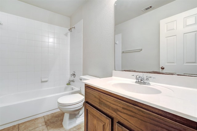 full bathroom with tiled shower / bath, vanity, toilet, and tile patterned flooring