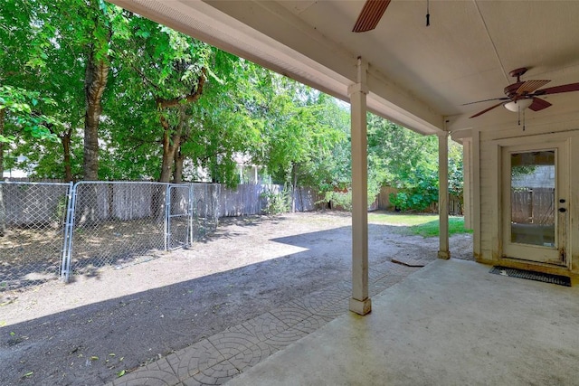 view of patio featuring a ceiling fan, a fenced backyard, and a gate